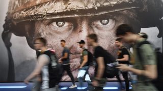 FILE - Visitors passing an advertisement for the video game 'Call of Duty' at the Gamescom fair for computer games in Cologne, Germany, Tuesday, Aug. 22, 2017. (AP Photo/Martin Meissner, File)