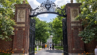 People walk through the gate on Harvard Yard at the Harvard University campus on June 29, 2023 in Cambridge, Massachusetts.