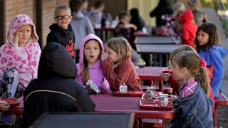 Third graders have lunch outdoors at Highland Elementary School in Columbus, Kan., on Monday, Oct. 17, 2022. (AP Photo/Charlie Riedel)