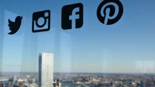 Icons for Twitter, Instagram, Facebook and Pinterest are displayed on a window, Wednesday, Jan. 13, 2016, in New York. (AP Photo/Mark Lennihan)
